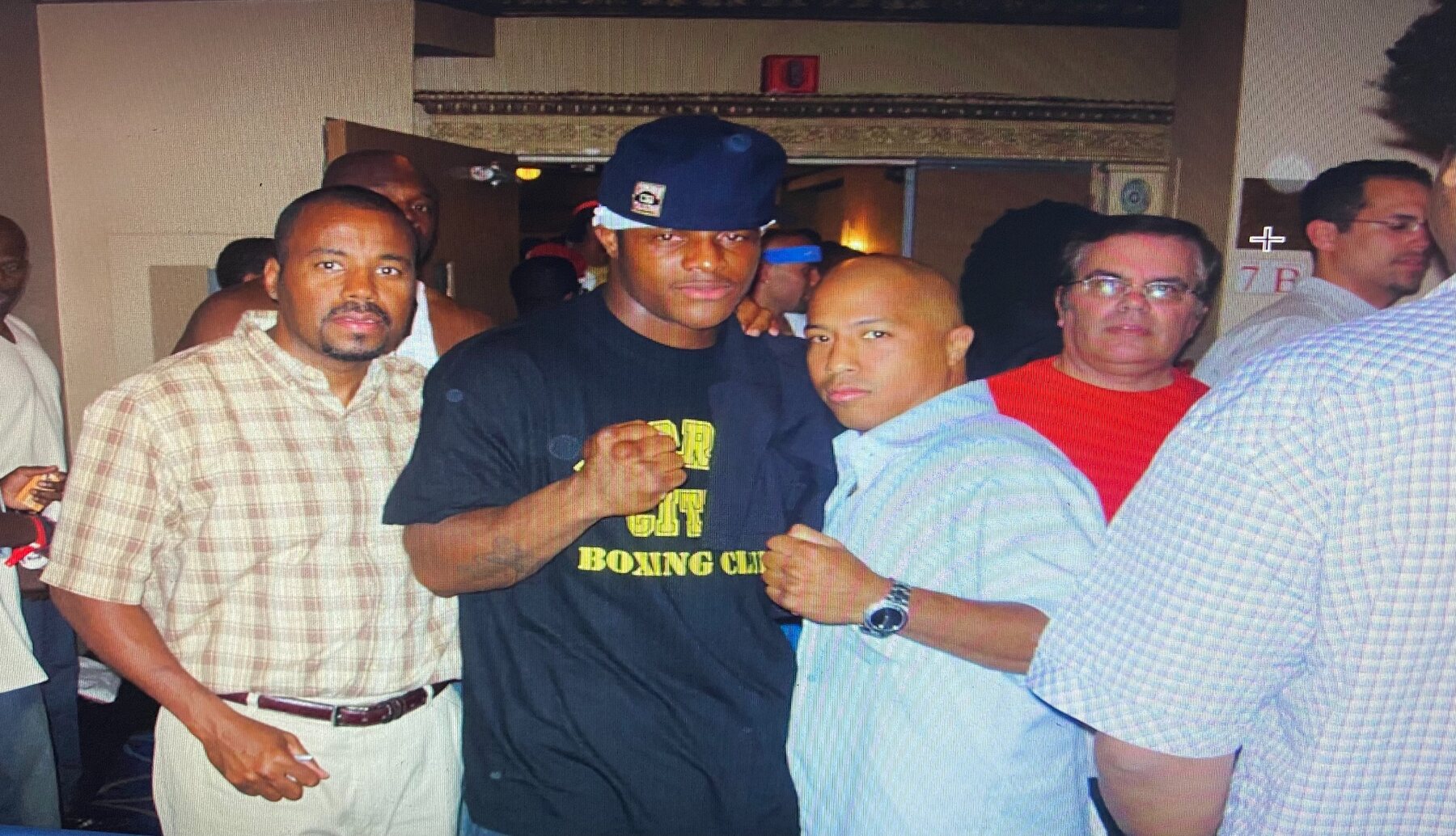 Coach Wacho with boxing figures at fight night