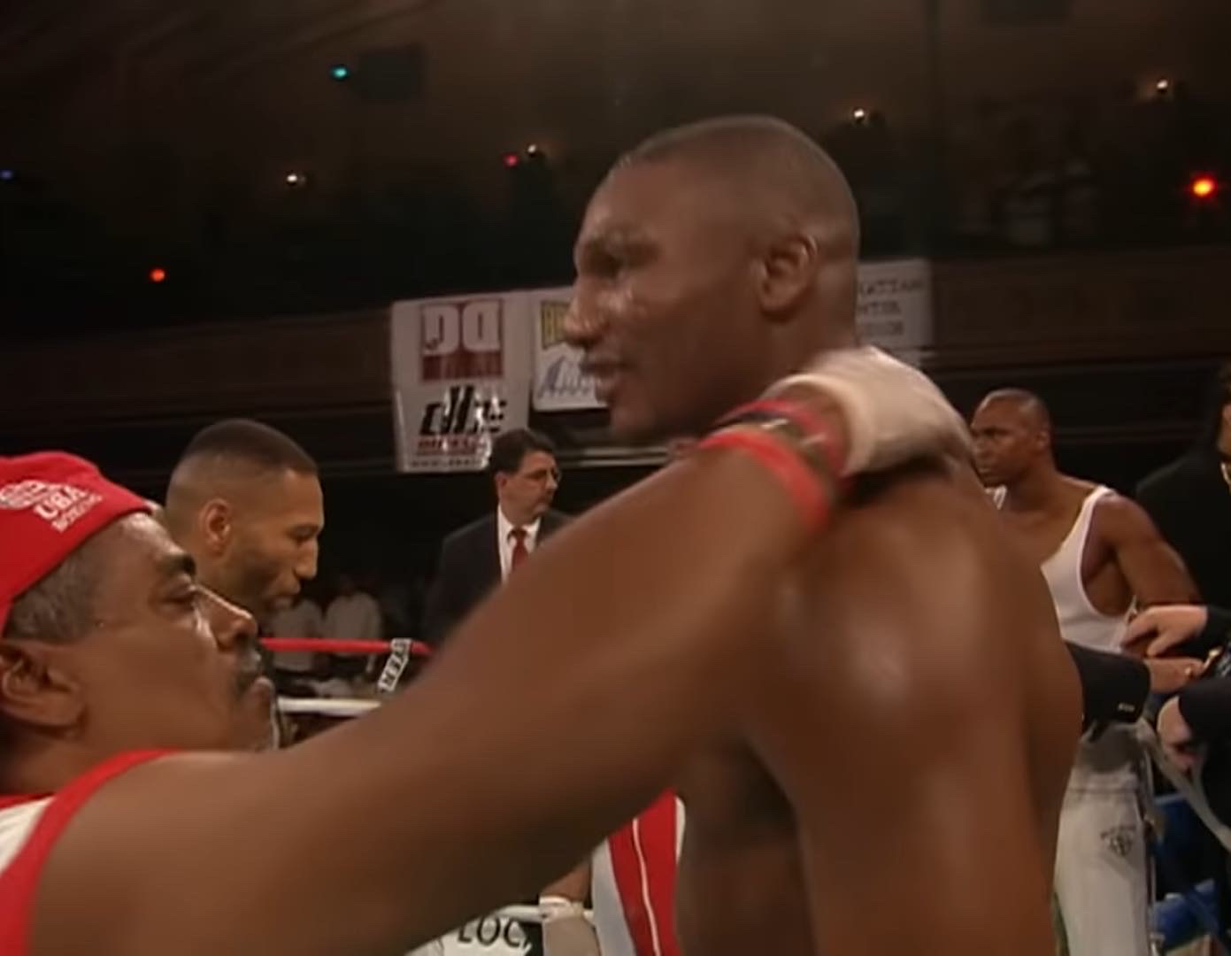 Cutman Manuel Diablito Calderon, in a red cap, working with a boxer in the corner