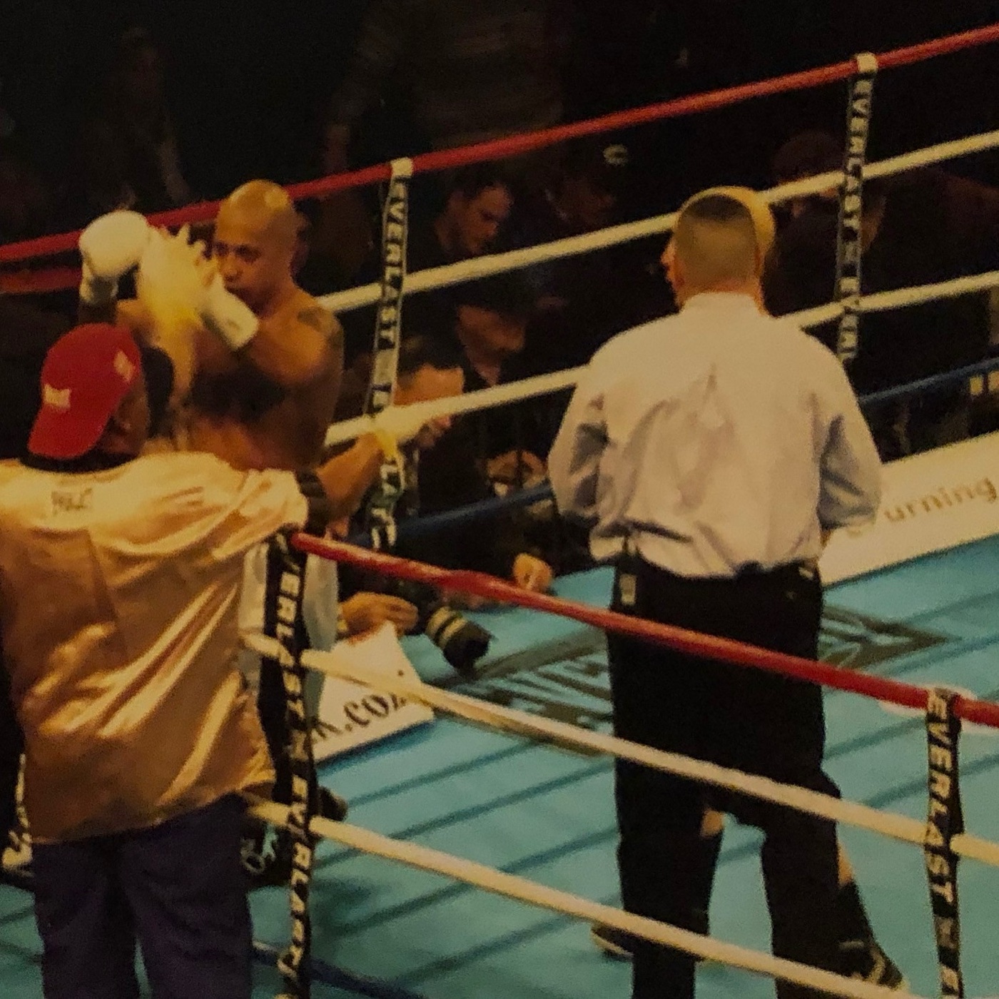 Professional boxer in the corner with his cornerman during a fight
